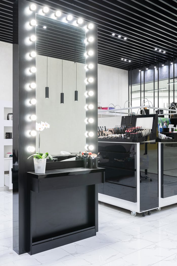 Contemporary makeup station featuring a large illuminated mirror and cosmetics display.